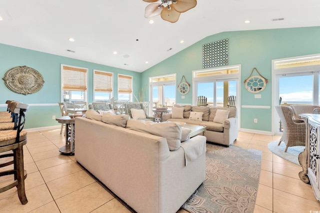 living room with light tile patterned flooring, vaulted ceiling, plenty of natural light, and ceiling fan