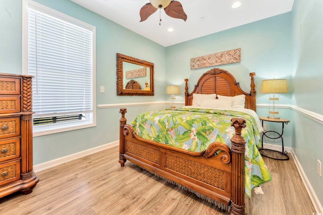 bedroom with light hardwood / wood-style floors and ceiling fan