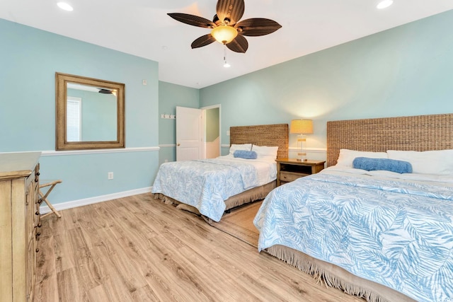 bedroom with ceiling fan and light hardwood / wood-style flooring