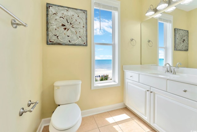 bathroom with toilet, vanity, a water view, and tile patterned floors