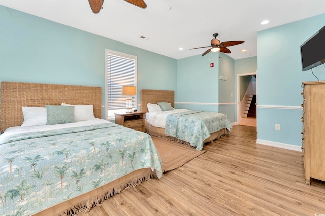 bedroom with ceiling fan and light hardwood / wood-style floors