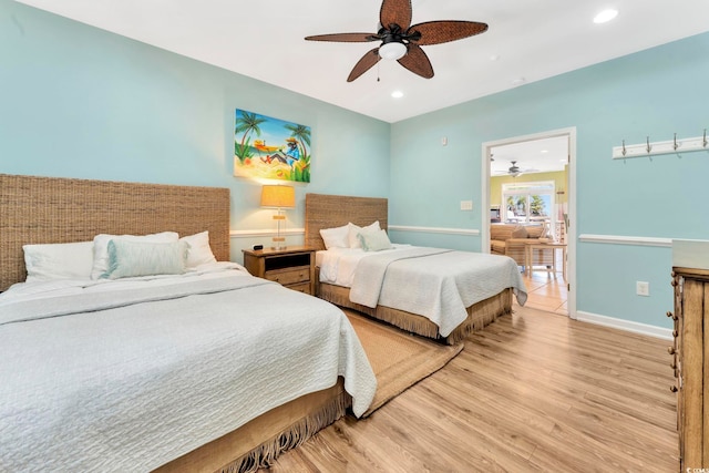 bedroom with light wood-type flooring and ceiling fan