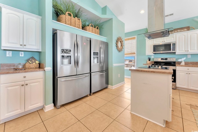 kitchen with white cabinets, stainless steel appliances, light tile patterned floors, and ventilation hood