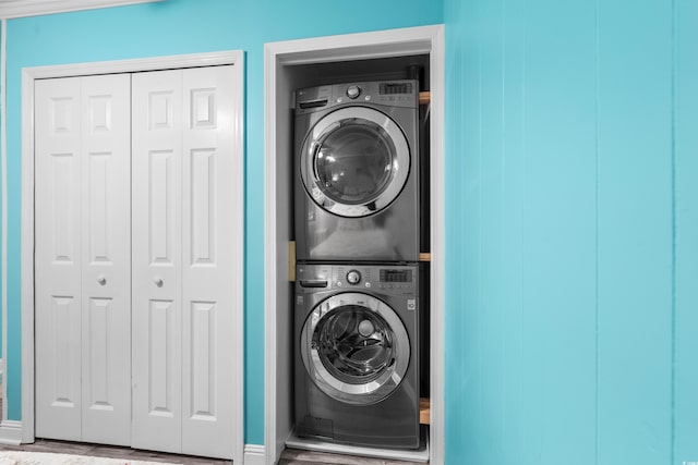 5601 N Ocean Blvd Unit C-305, Myrtle Beach, SC 29577 - washroom with stacked washer / dryer, baseboards, and wood finished floors