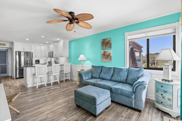 5601 N Ocean Blvd Unit C-305, Myrtle Beach, SC 29577 - living room featuring a ceiling fan, light wood-style floors, a textured ceiling, recessed lighting, and baseboards