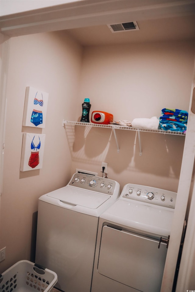 clothes washing area with independent washer and dryer