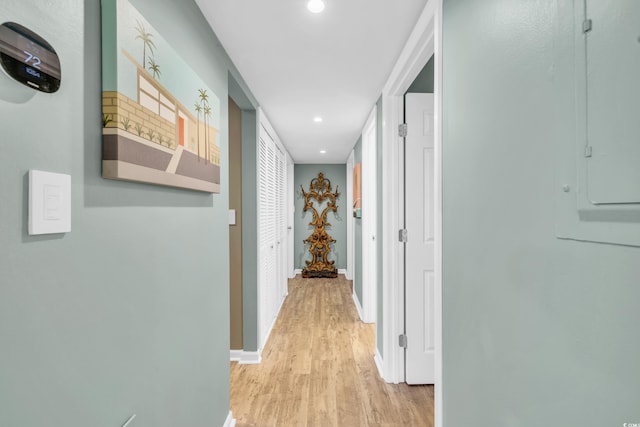 hall featuring electric panel and light wood-type flooring