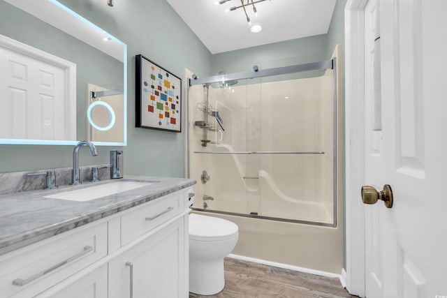 full bathroom featuring toilet, combined bath / shower with glass door, vanity, and hardwood / wood-style flooring