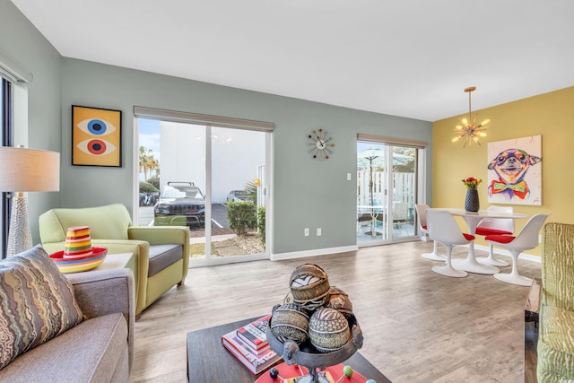 living room featuring a chandelier and light hardwood / wood-style flooring