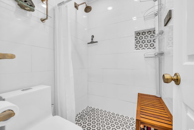 bathroom with toilet and a shower with shower curtain