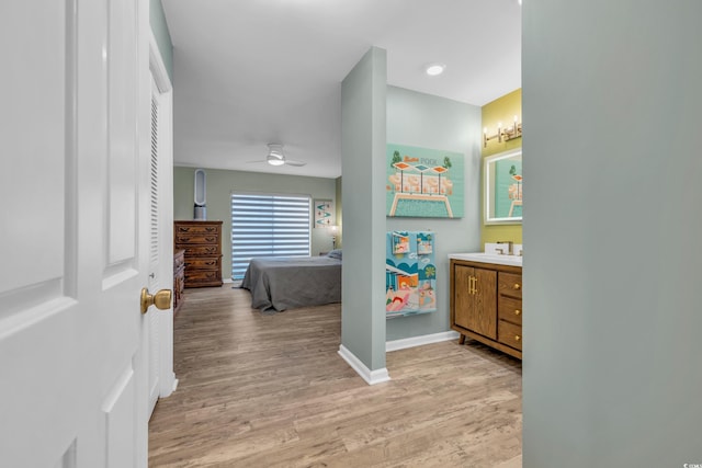 bathroom with vanity, hardwood / wood-style flooring, and ceiling fan