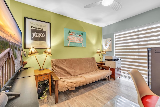 living area with light wood-type flooring and ceiling fan