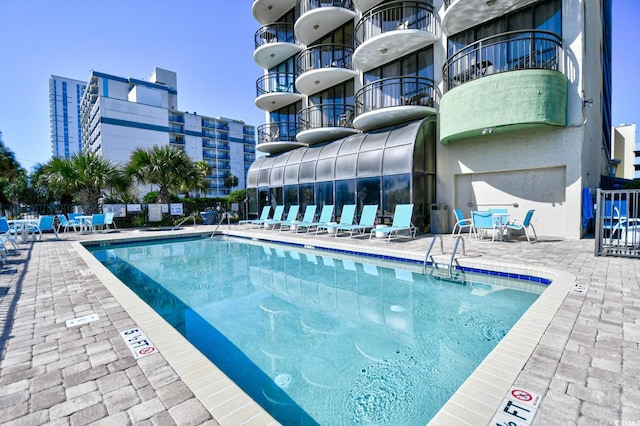 view of swimming pool featuring a patio area