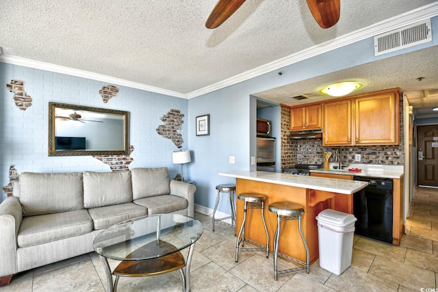 kitchen featuring dishwasher, a kitchen bar, ornamental molding, and a textured ceiling