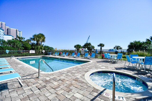 view of pool with a patio area and a community hot tub