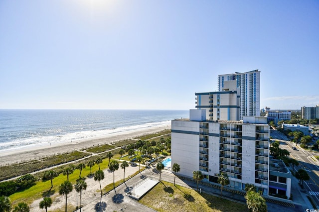 drone / aerial view featuring a water view and a beach view