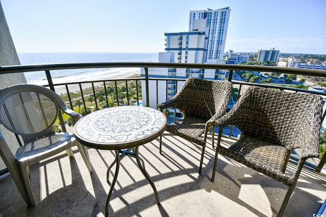 balcony featuring a water view and a beach view