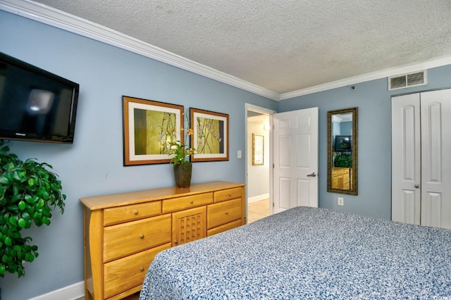 bedroom featuring a textured ceiling, a closet, and crown molding