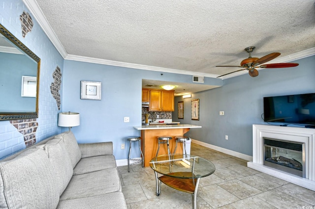 tiled living room with crown molding, ceiling fan, and a textured ceiling