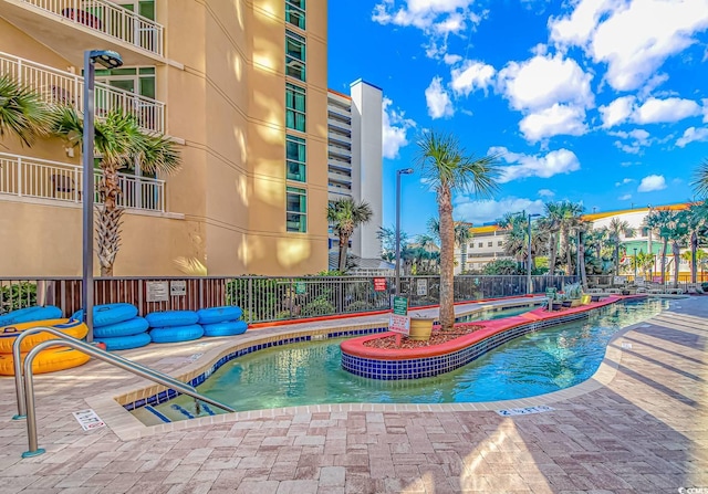 view of swimming pool with a patio area