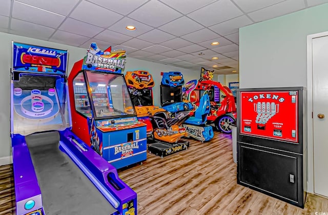 game room with hardwood / wood-style floors and a drop ceiling