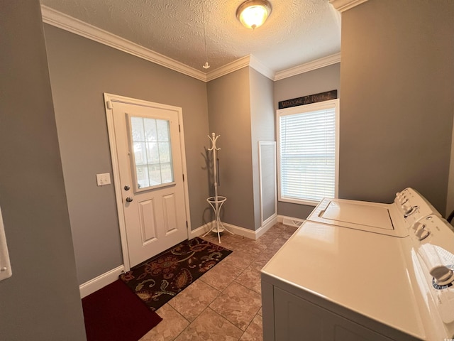 laundry area featuring a textured ceiling, light tile patterned floors, separate washer and dryer, and crown molding