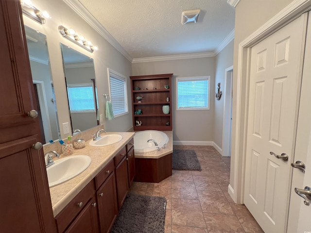 bathroom with tile patterned floors, crown molding, vanity, a textured ceiling, and a tub