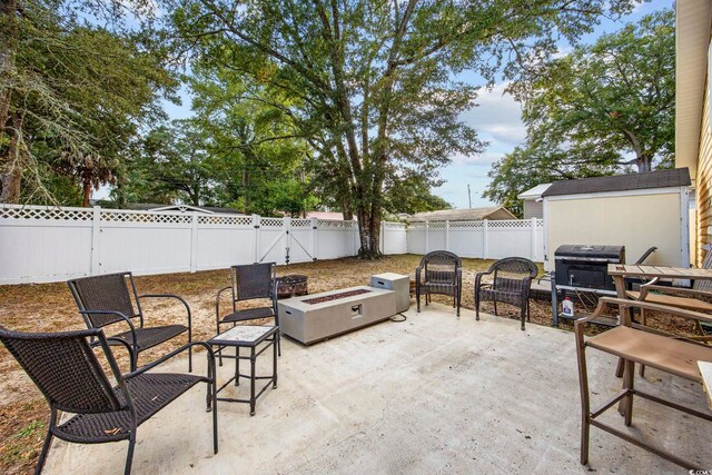 view of patio featuring a fire pit and a grill