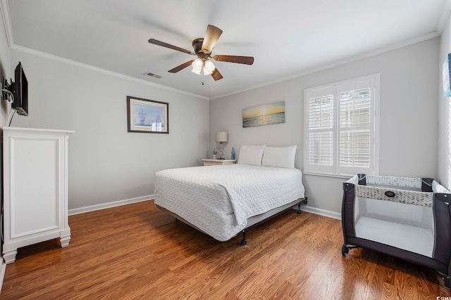 bedroom featuring ceiling fan, wood-type flooring, and ornamental molding