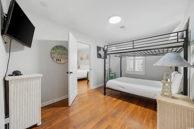 bedroom with hardwood / wood-style floors