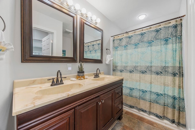 bathroom with a shower with shower curtain and vanity