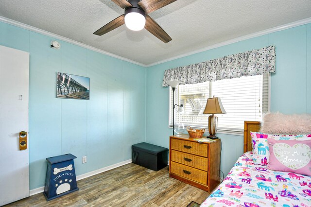 4305 S Ocean Blvd Unit 205, North Myrtle Beach, SC 29582 - bedroom featuring crown molding, wood finished floors, a textured ceiling, and ceiling fan