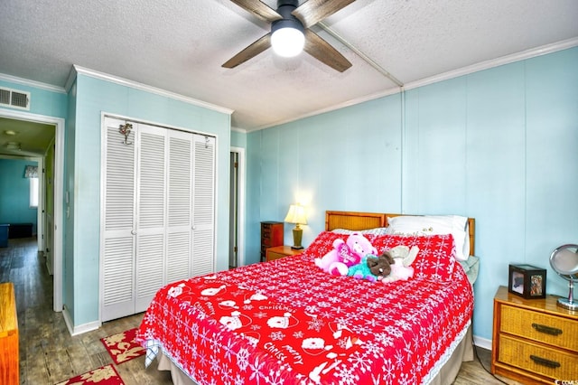 4305 S Ocean Blvd Unit 205, North Myrtle Beach, SC 29582 - bedroom featuring crown molding, wood finished floors, a textured ceiling, a closet, and a ceiling fan