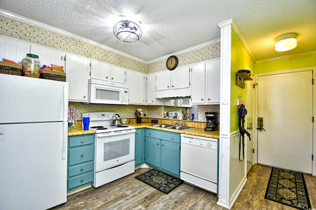 kitchen with dark hardwood / wood-style flooring, white appliances, blue cabinets, crown molding, and white cabinets