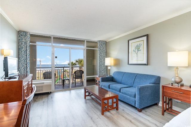 living room with ornamental molding, light hardwood / wood-style flooring, and floor to ceiling windows