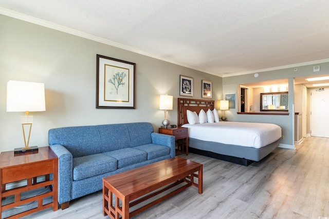 bedroom featuring wood-type flooring, a textured ceiling, and crown molding