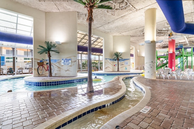 view of swimming pool featuring a jacuzzi