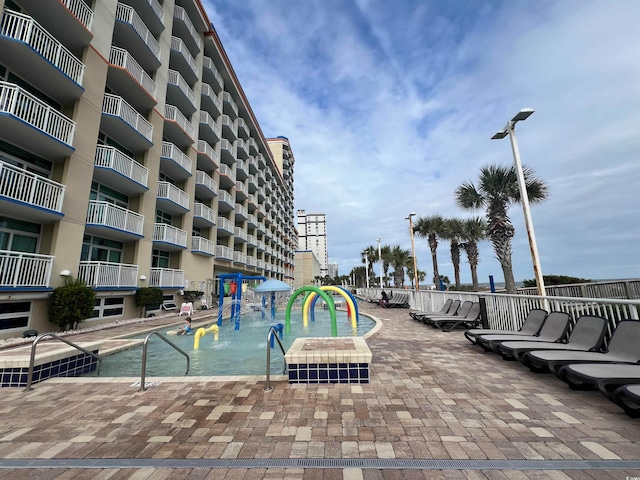 view of swimming pool with pool water feature