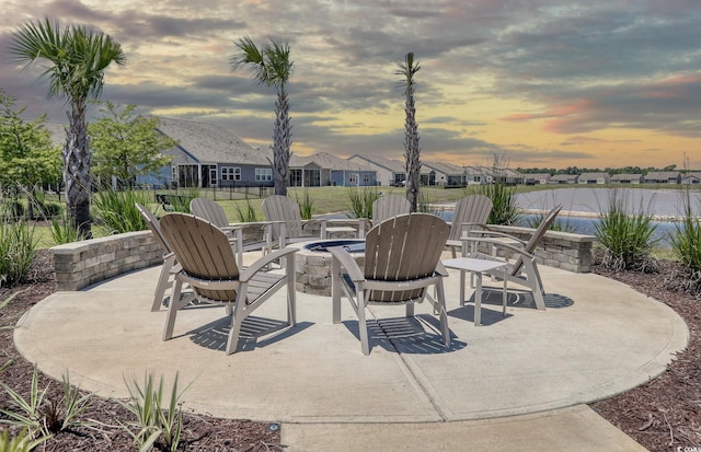 patio terrace at dusk featuring an outdoor fire pit