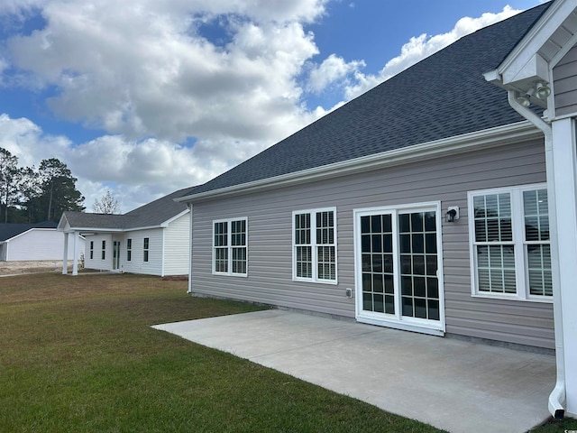 rear view of house with a patio and a yard