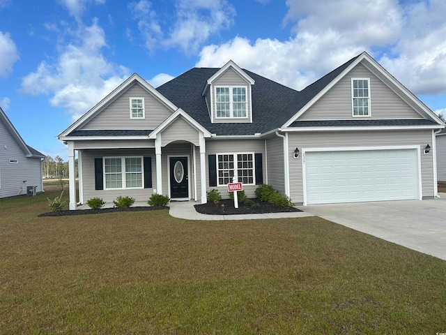 view of front of house with a front lawn and a garage