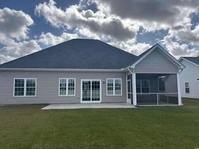 2327 King Farm Rd, Aynor, SC 29511 - rear view of house featuring roof with shingles, a sunroom, a patio, and a yard