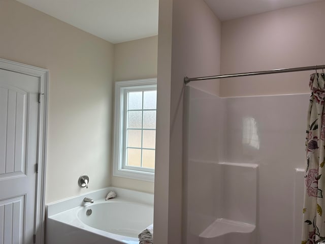 bathroom featuring plus walk in shower