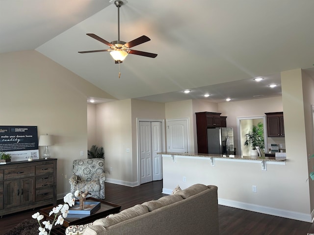 living room featuring lofted ceiling, dark hardwood / wood-style floors, and ceiling fan