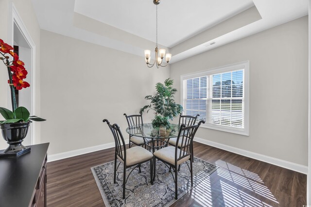 2327 King Farm Rd, Aynor, SC 29511 - dining area featuring a notable chandelier, a tray ceiling, baseboards, and dark wood finished floors