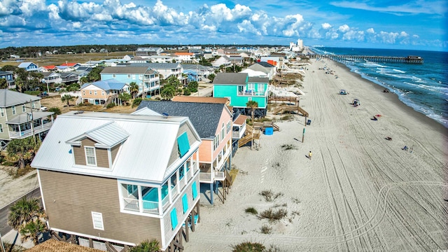 drone / aerial view with a water view and a view of the beach