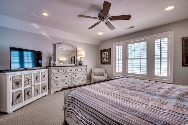 bedroom with ceiling fan, light carpet, and lofted ceiling