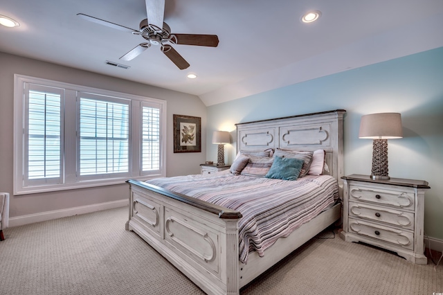 bedroom with vaulted ceiling, light carpet, and ceiling fan