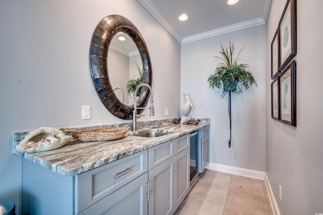 bar with light tile patterned floors, light stone countertops, sink, and crown molding