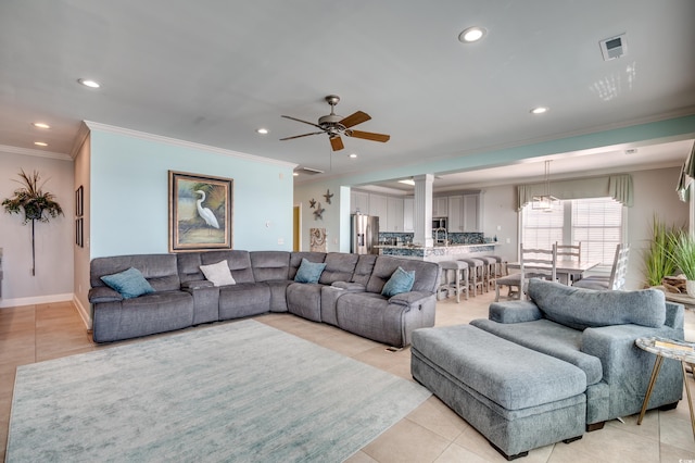 tiled living room featuring ceiling fan and crown molding